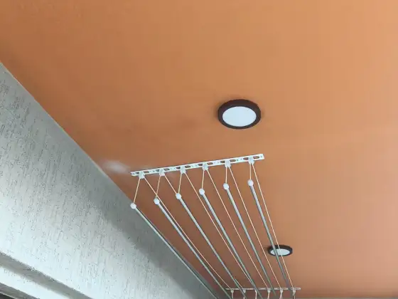 Ceiling-mounted drying hanger on a balcony (wider view)