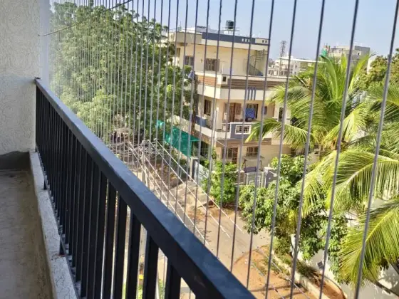 Invisible grill fitted across an apartment balcony in Chennai