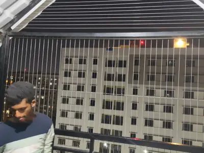 Invisible grill fitted across an apartment balcony in Chennai (close-up view)