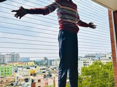 Stainless-steel cable grill on a high-rise balcony in Chennai (wider view)