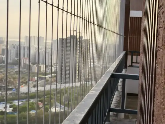 Invisible grill fitted across an apartment balcony (site photo)