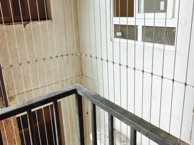 Stainless-steel cable grill on a high-rise balcony in Chennai (completed work)
