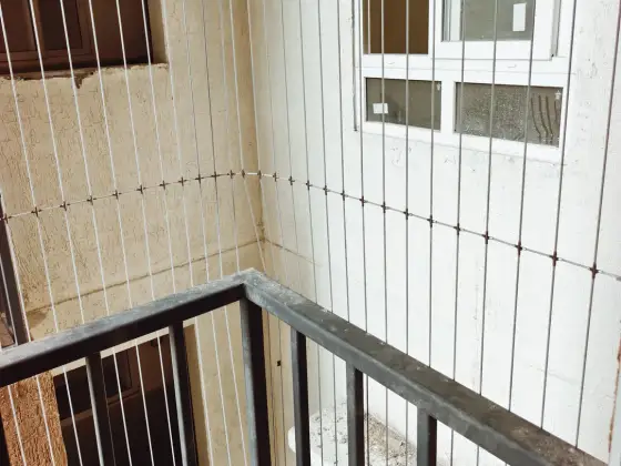 Stainless-steel cable grill on a high-rise balcony (completed work)