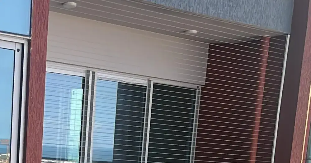 Cable grill over a window opening