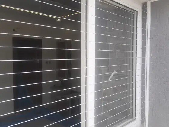 Window secured with an invisible grill