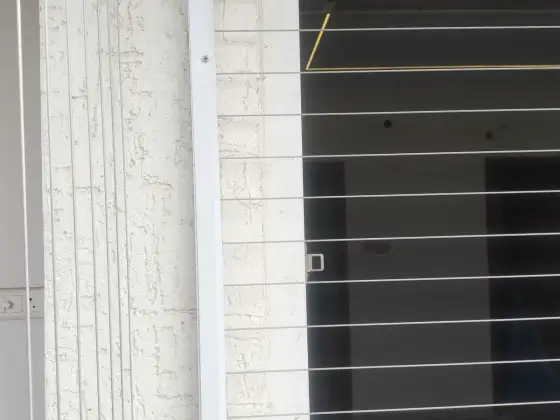 Invisible grill fitted on an apartment window (close-up view)