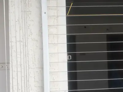 Invisible grill fitted on an apartment window in Chennai (close-up view)