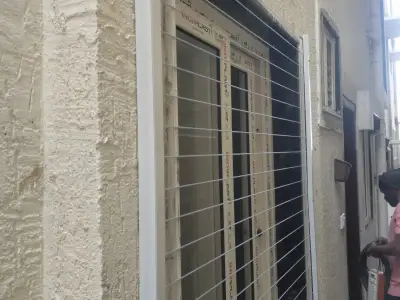 Cable grill over a window opening (close-up view)