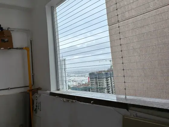 Invisible grill fitted on an apartment window in Avadi, Chennai (wider view)