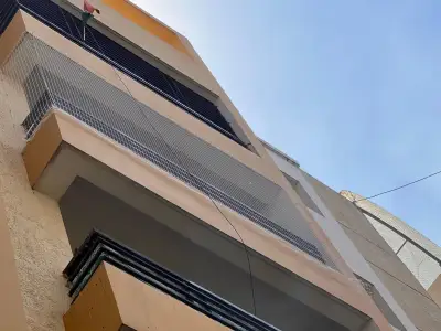 Pigeon net fitted across an apartment balcony in Chennai