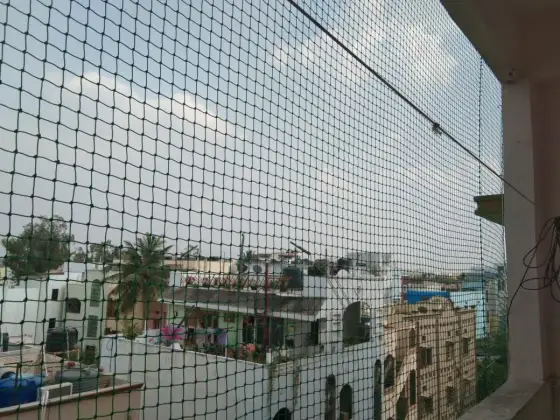 Balcony bird-proofed with a pigeon net (close-up view)