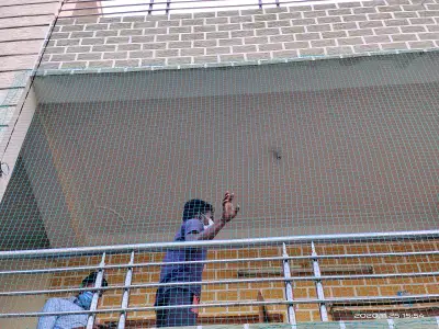 Pigeon net installed on a high-rise balcony (close-up view)