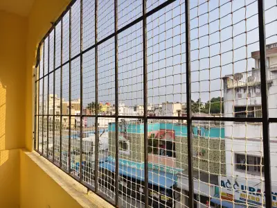 Pigeon net fitted across an apartment balcony in Chennai (wider view)