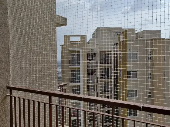 Balcony bird-proofed with a pigeon net (wider view)