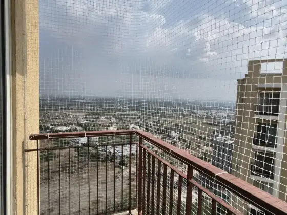 Pigeon net installed on a high-rise balcony in OMR, Chennai (wider view)