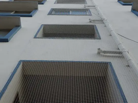 Duct shaft bird-proofed with fine netting (close-up view)