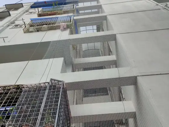 Pigeon net over an AC duct opening (close-up view)
