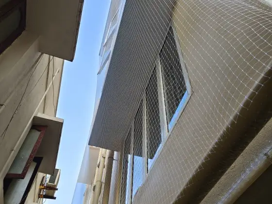 Window ledge protected with a pigeon net in Red Hills, Chennai (close-up view)