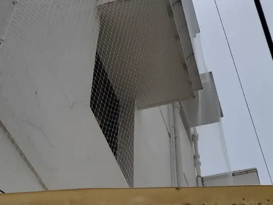 Bird net fitted over an apartment window (wider view)
