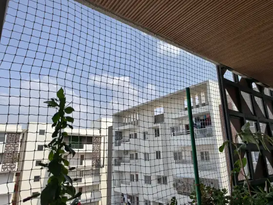 Safety net fitted across an apartment balcony (close-up view)