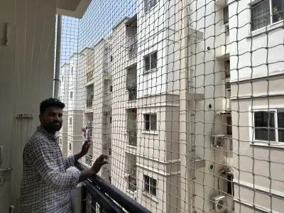 Tensioned safety net on a high-rise balcony in Chennai (close-up view)