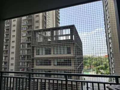 Safety net fitted across an apartment balcony in Chennai (wider view)