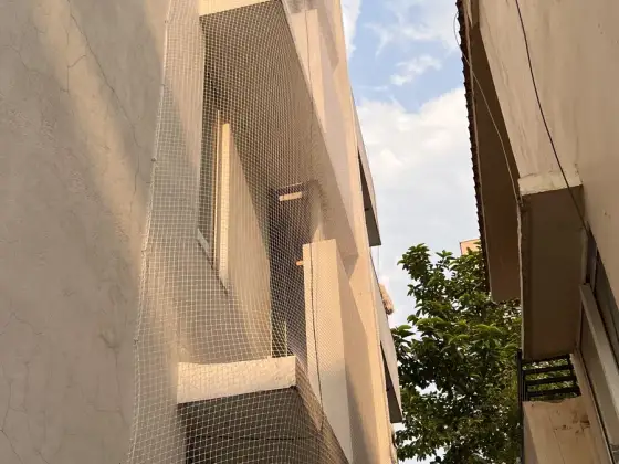 Safety nets covering an apartment building facade (close-up view)