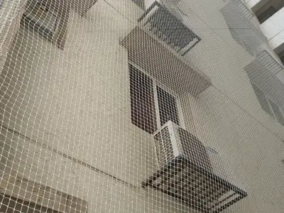 Safety nets covering an apartment building facade in Chennai (close-up view)