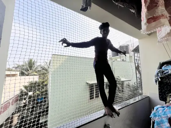 Fine-mesh safety net protecting a child's play area in Pallikaranai, Chennai