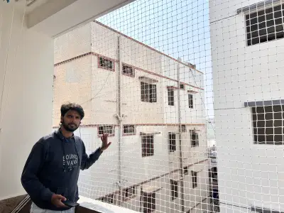 Child safety net fitted on an apartment balcony in Chennai (close-up view)