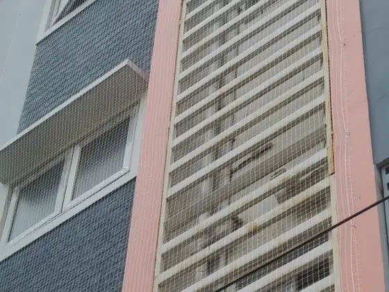 Net over an open service duct in a residential building