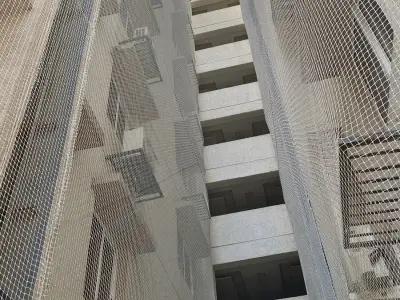 Net over an open service duct in a residential building in Chennai (close-up view)