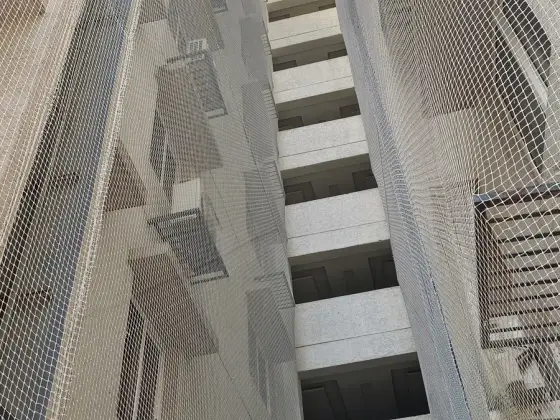Net over an open service duct in a residential building in Madipakkam, Chennai (close-up view)