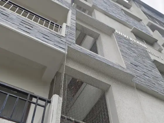 Net over an open service duct in a residential building in Teynampet, Chennai (wider view)