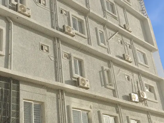 Pigeon net covering an apartment building facade in Chennai