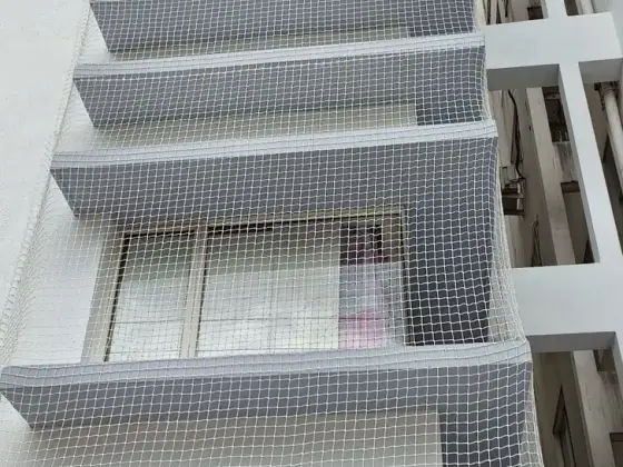 Window safety net fitted on an apartment (close-up view)