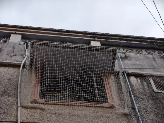 Safety net over a window opening on a high floor in Triplicane, Chennai (close-up view)