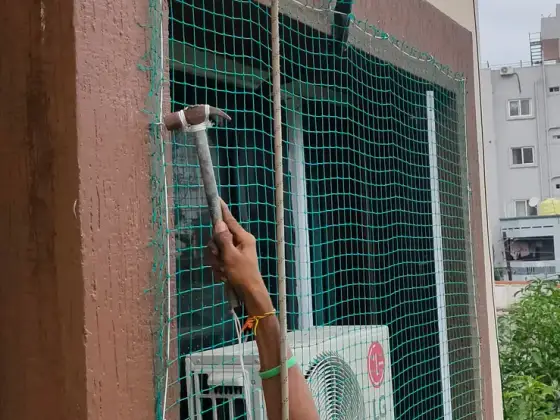 Safety net over a window opening on a high floor (wider view)