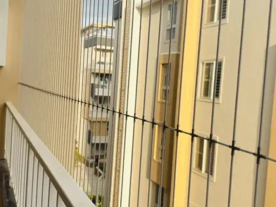 Vertical invisible grill on an apartment balcony in Thiruvanmiyur, Chennai (close-up view)