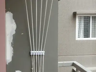 Wall-mounted cloth hanger fitted on a balcony wall in Chennai (close-up view)