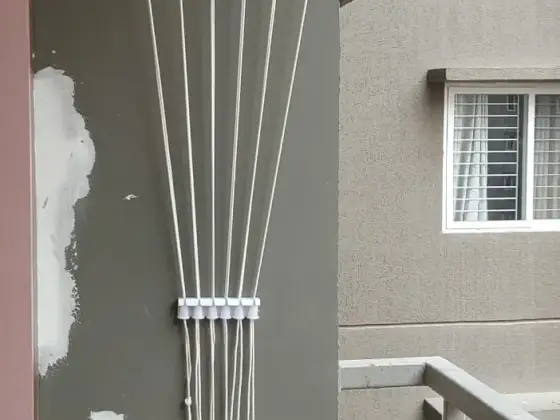 Wall-mounted cloth hanger fitted on a balcony wall in Tambaram, Chennai (close-up view)