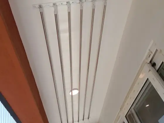 Wall-mounted drying hanger in a utility area (close-up view)