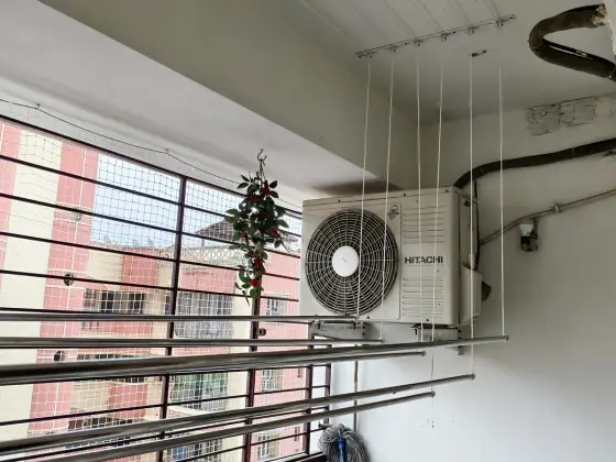 Wall-mounted cloth hanger fitted on a balcony wall (wider view)